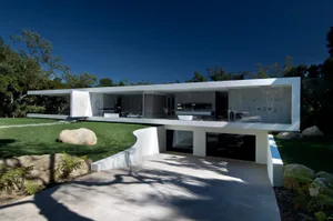 Modern house featuring a glass and concrete structure.