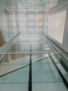 A modern interior space with glass walls and a sleek design.