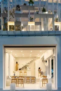 Contemporary coffee shop interior with minimalist design elements and natural lighting.
