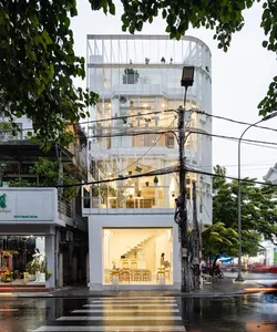Modern restaurant with glass storefront and interior with bar seating.