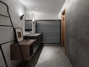 Modern minimalist bathroom with ceramic tiles, floating vanity, and frosted glass partition.