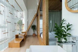 A modern bedroom featuring wooden furniture and large windows.