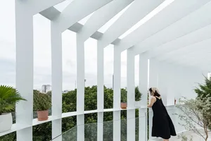 A modern interior design featuring floating glass railings and columns.