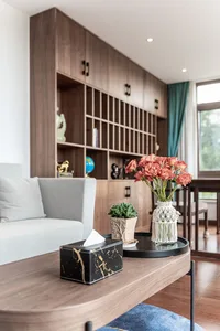 A modern living room featuring wooden furniture and decorative accents.