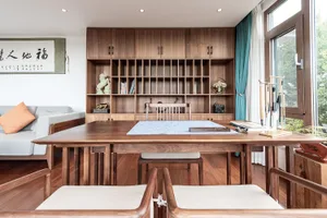 A modern living room featuring wooden shelves, a sofa, and a table with various decorative items.