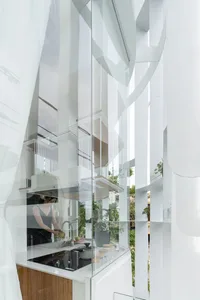 A modern residential kitchen designed with glass panes, featuring a sleek and minimalistic aesthetic.