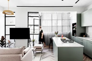A modern kitchen featuring marble countertops and a minimalist design.