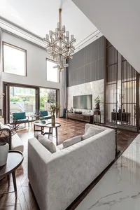 Modern living room featuring a marble floor and hardwood tabletop surfaces.