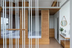 Minimalist design bathroom with wooden accents and white fixtures.