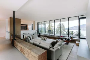 Modern living room featuring reclaimed wood accents and a scenic view.