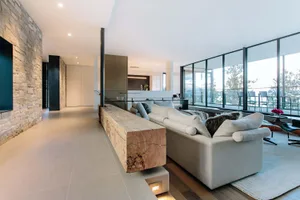 Modern living room featuring wood, stone, and glass materials