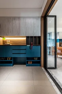 Modern blue entry way with contemporary cabinets and storage solutions.