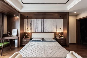 A minimalist bedroom with wooden furniture, white bedding, and a forest mural