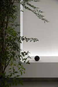 A minimalist interior design featuring a concrete sphere