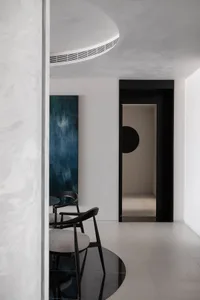 A minimalist interior design featuring concrete walls and furniture.