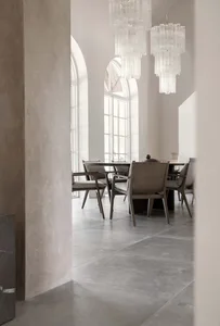 Modern dining room featuring concrete and glass chandelier