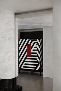 Modern interior design featuring a black and white geometric pattern on a wall.