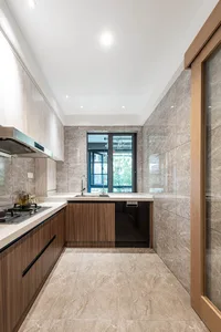 Modern, minimalist kitchen with marble countertops and flooring.