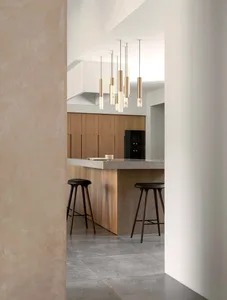 Modern kitchen featuring wooden cabinets and a marble countertop.