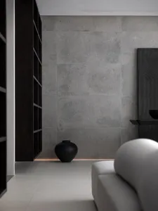 Modern living room with concrete wall and white sofa.
