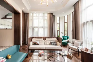 Modern living room with wooden furniture, leather accents, and glass coffee table.