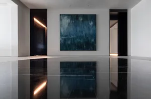 A modern lobby with concrete walls and floors.