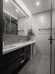 Modern bathroom with marble tiles, double sink vanity, and walk-in shower.