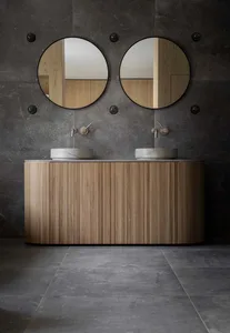 Modern bathroom with dark grey tiles, oak vanity unit, and two sinks with mirrors.