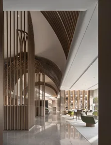 Modern hotel lobby featuring wood, glass, and marble materials.