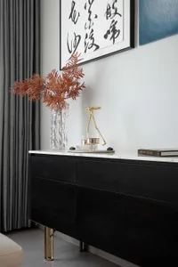 Modern interior design featuring brass legs and black wood furniture.