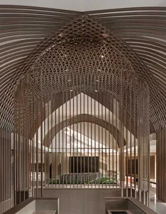 A modern interior space featuring tall, criss-cross patterned walls.