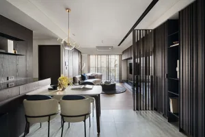 Modern living room with wooden furniture, glass coffee table, and metal accents.