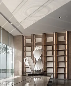 A modern lobby featuring glass walls and a geometric sculpture