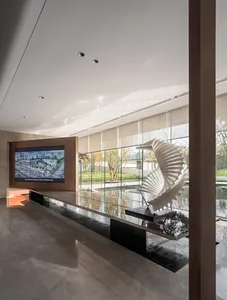 A modern lobby featuring glass, steel, and marble materials.