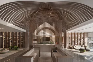 Modern lobby with high ceiling, bookshelves, and seating area