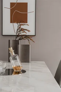 Modern dining room with marble table and minimalist decor.
