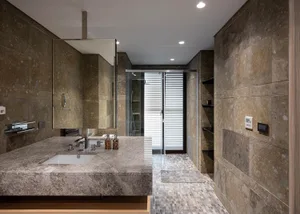 Modern minimalist bathroom featuring marble tiles and mosaic floor