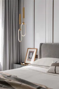 A minimalist bedroom showcasing a neatly made bed with modern lighting and decorative elements.