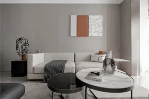 A modern minimalist living room featuring neutral-toned furniture and decor.