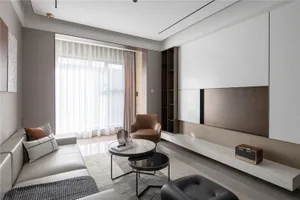 A modern living room with white marble finishes, a comfortable sofa, and minimalist furniture.