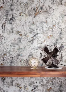 An industrial-themed desk display featuring an antique clock and a metal fan.