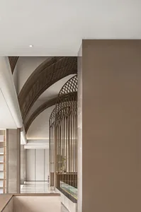 Modern interior design featuring a corner staircase with concrete walls, steel railings, and glass panels.