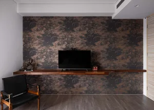 A modern living room featuring a wooden wall with a mounted television and a sleek, black chair.