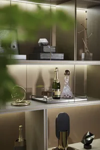 A stylish modern bar display featuring gold accessories and a bottle of champagne.