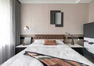 A modern bedroom featuring a bed with a white blanket, a tufted leather headboard, and minimalist decor.