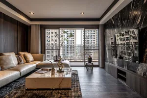 Modern living room with marble coffee table, leather sofa, and metal accents