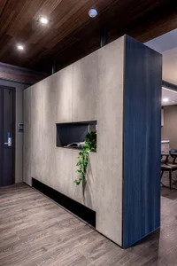 Modern office space with minimalist design features concrete shelving unit for storage space.