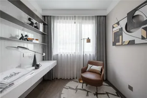 A modern home office with minimalist furniture and a comfortable armchair.