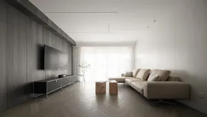 Interior design of a minimalist living room featuring wooden flooring, a beige sectional sofa, and a wall-mounted flat-screen