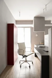 A modern office space featuring concrete and wood materials.
